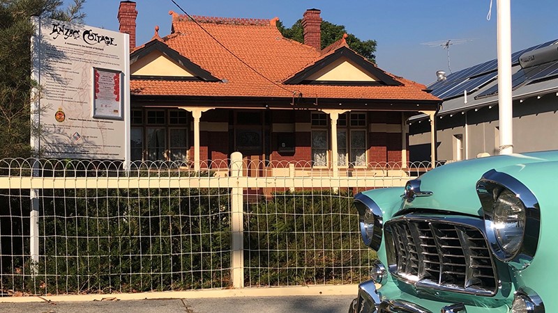 ANZAC Cottage, a small brick house built in 1916, with 1958 FE Holden in foreground.