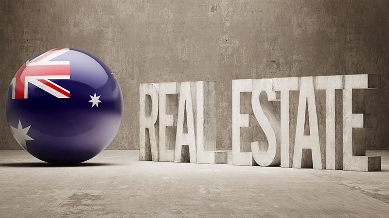 Real estate graphic with ball as Australian flag alongside blocks of text reading Real Estate.