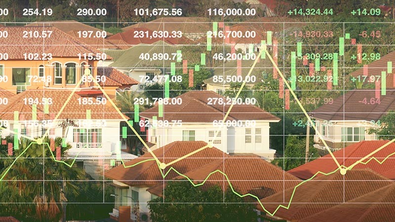Financial statistics overlaying image of real estate.