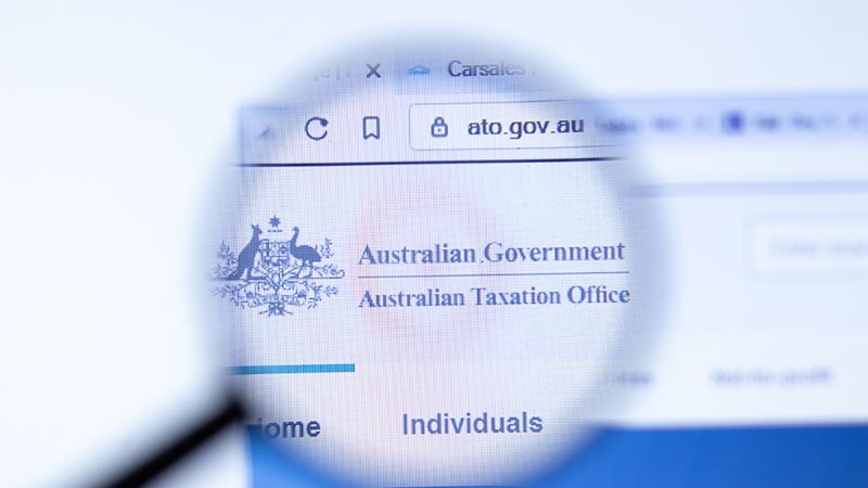 Australian Government Taxation Office ato.gov.au company website with logo seen through magnifying glass.