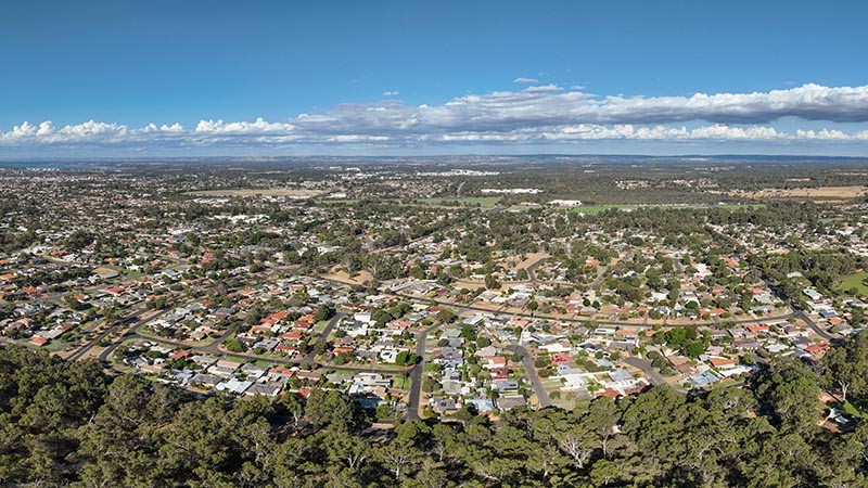 Wide drone panorama of Bunbury City from the south, accentuating the flat urban sprawl.